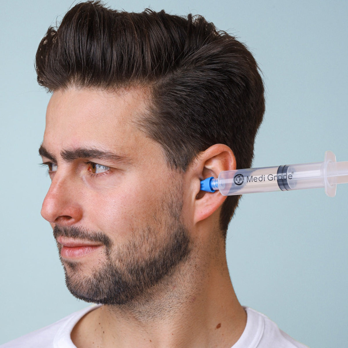A man using a Medi Grade Ear Wax Removal Syringe
