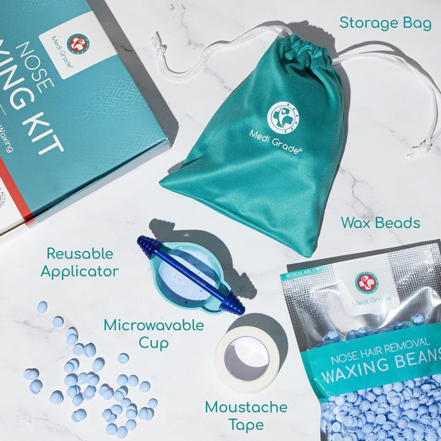 Flat lay of all of the nose wax kit accessories - wax beads, moustache tape, microwavable cup, reusable metal applicator, retail box