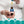 Load image into Gallery viewer, A hand holding a bottle of olive oil ear drops bottle and dropper with icons below for handy dropper, medically filtered, gentle action, &amp; travel size bottle
