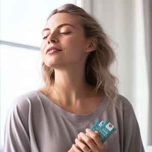 Woman holding 2 Medi Grade nasal rinse sachets