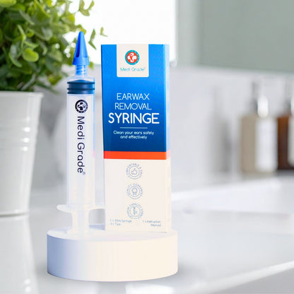 Medi Grade earwax removal syringe with packaging on a bathroom counter.