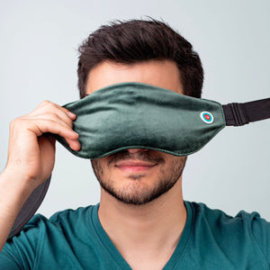 A man putting on a heated eye mask