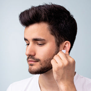 A man about to put silicone earplugs