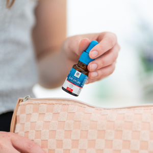 Olive oil ear drops bottle being placed inside a pouch