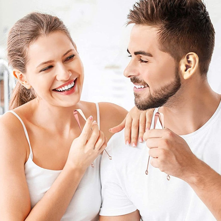 Man and woman looking at each other while each holding a tongue scraper