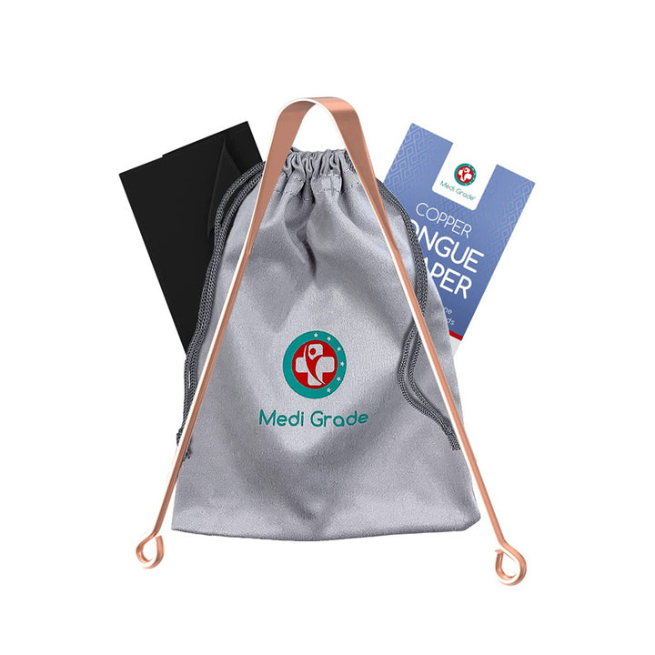 Tongue scraper in front of a drawstring bag, black cloth, and instruction manual
