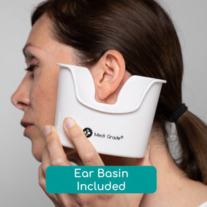 Woman holding an ear basin below her ear