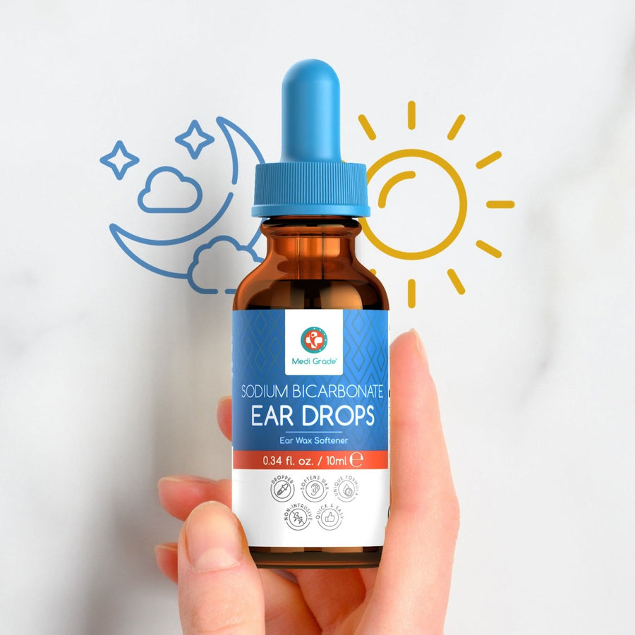 Hand holding the Sodium Bicarbonate Ear Drops with sun and moon beside the bottle