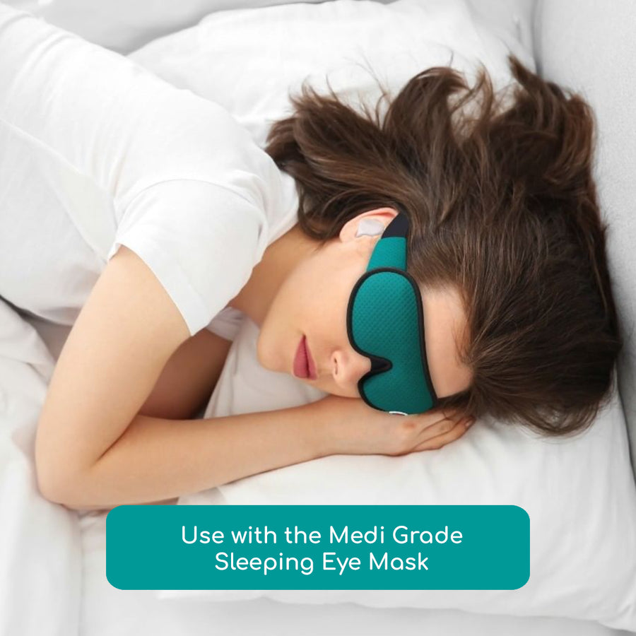 Woman sleeping while wearing a sleep eye mask and earplugs